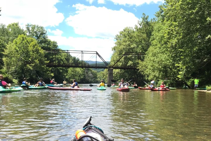 a group of people rowing a boat in the water