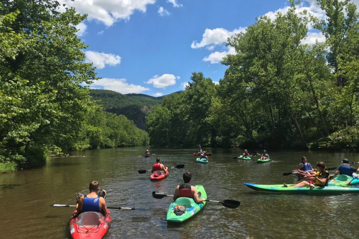 a group of people in a small boat in a body of water