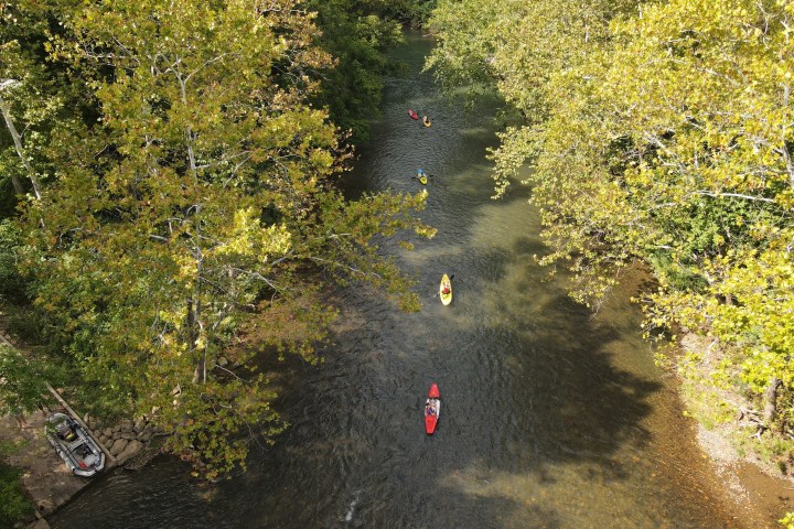 a group of people sitting on the side of the road