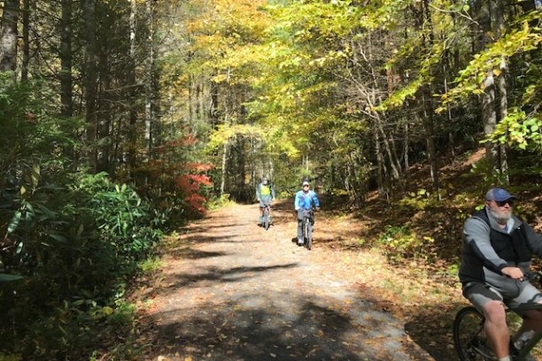 a man riding a bike down a dirt road